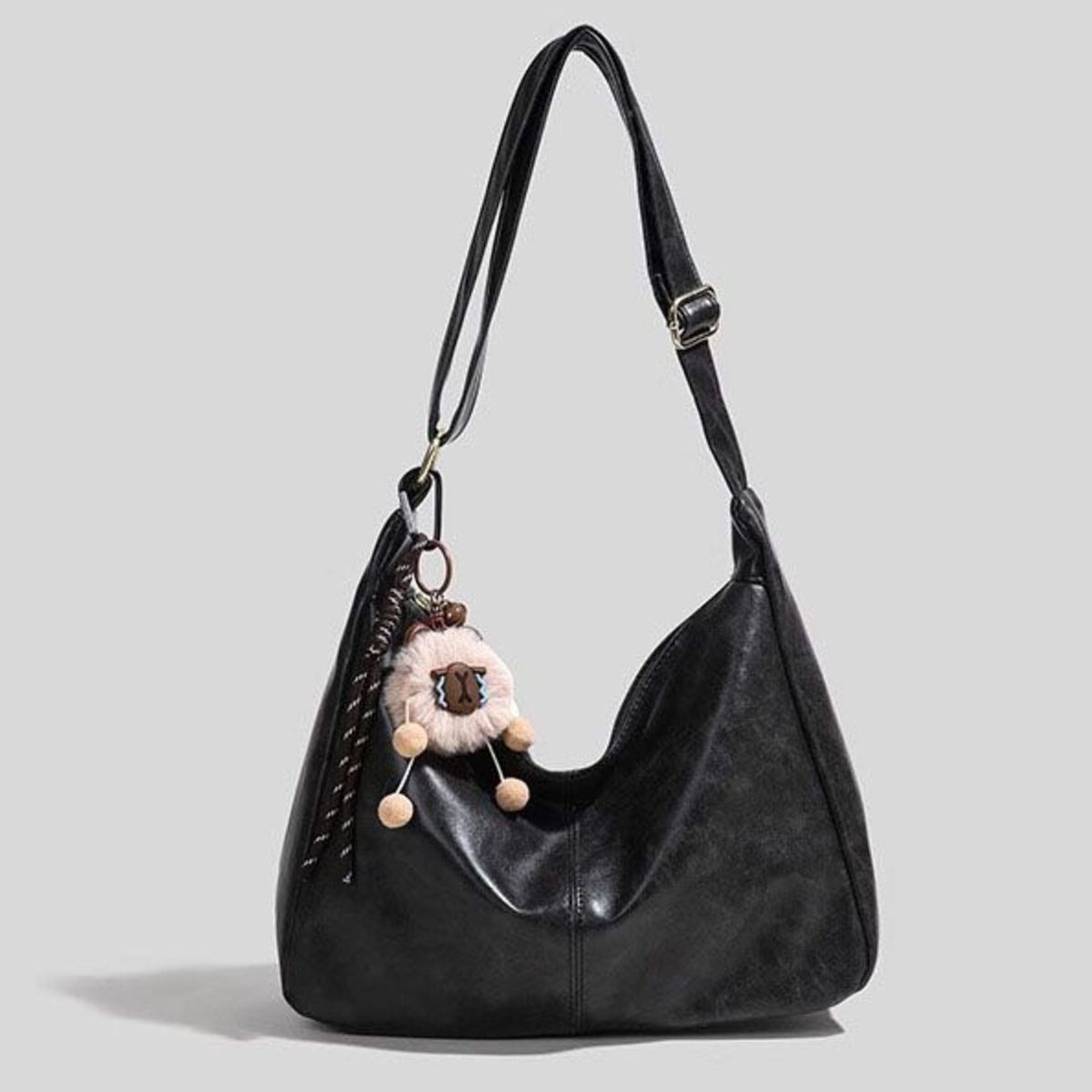Large vintage black hobo shoulder bag with sheep charm and braided strap detail