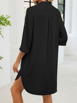 Black button-down shirt dress with band collar, three-quarter sleeves, and side slits.