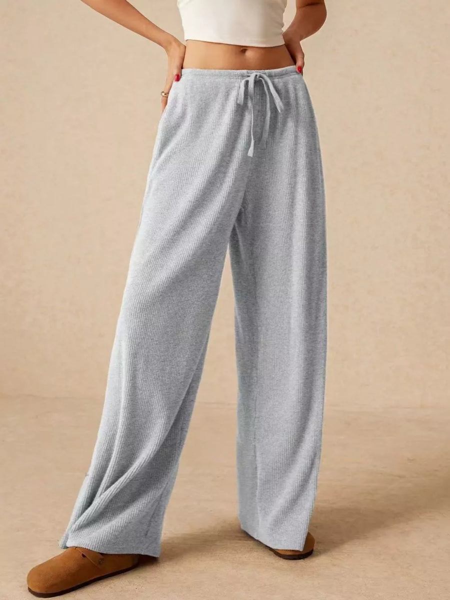 Gray ribbed wide-leg drawstring pants with a relaxed fit.