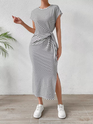 Black and white striped midi dress with tie-side detail and thigh slit.