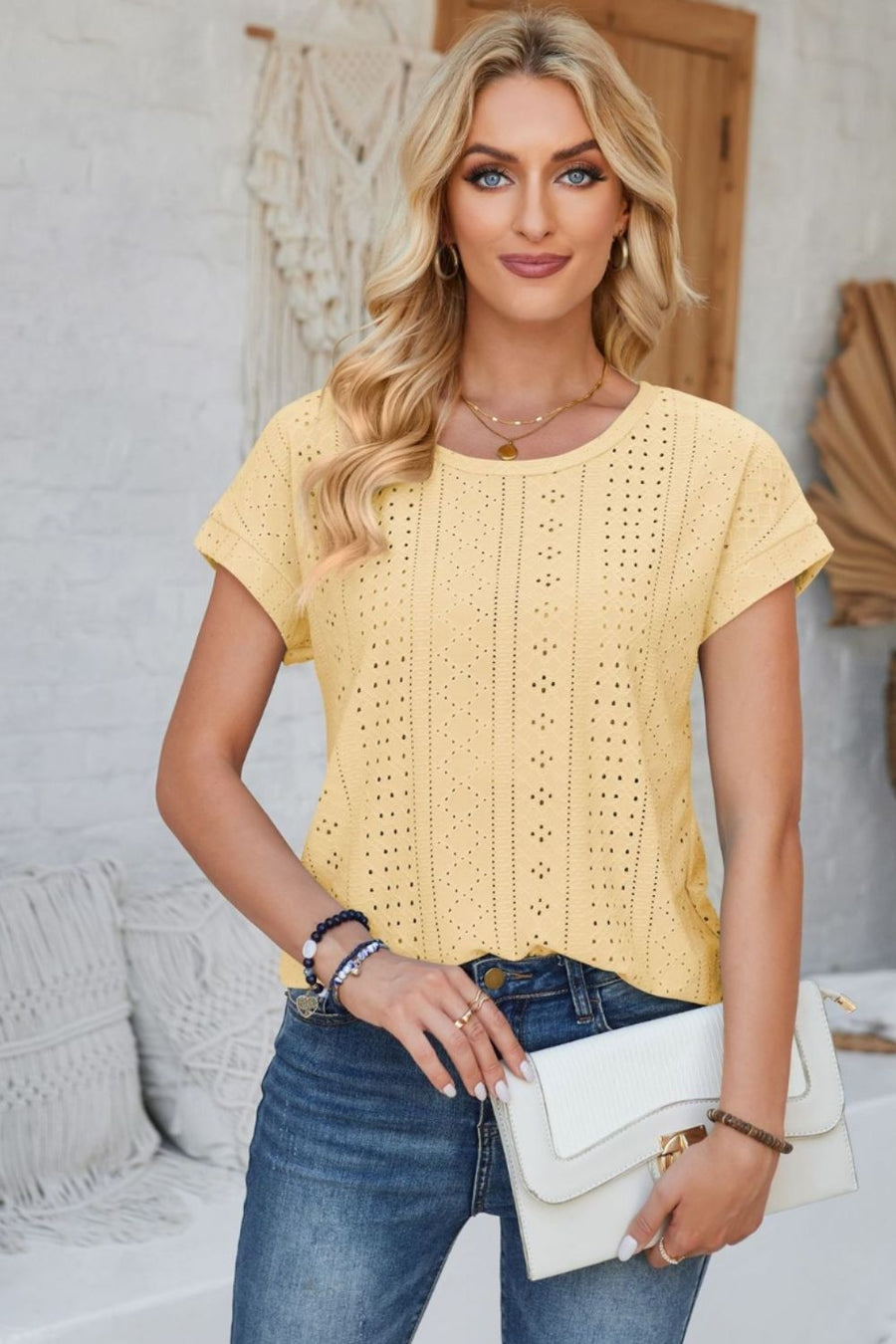 Light Yellow perforated eyelet cuffed tee with short sleeves and a round neckline.