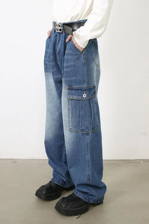 Faded denim cargo pants in medium wash with pleated cargo pockets and a relaxed fit.