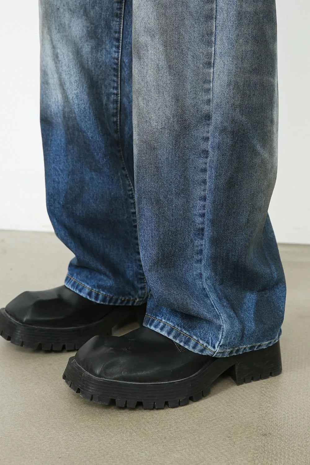 Faded ombre wide-leg jeans in medium blue denim, showing a gradient wash and relaxed fit.