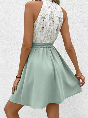 Floral print halter neck a-line dress with tie detail and sage green skirt.