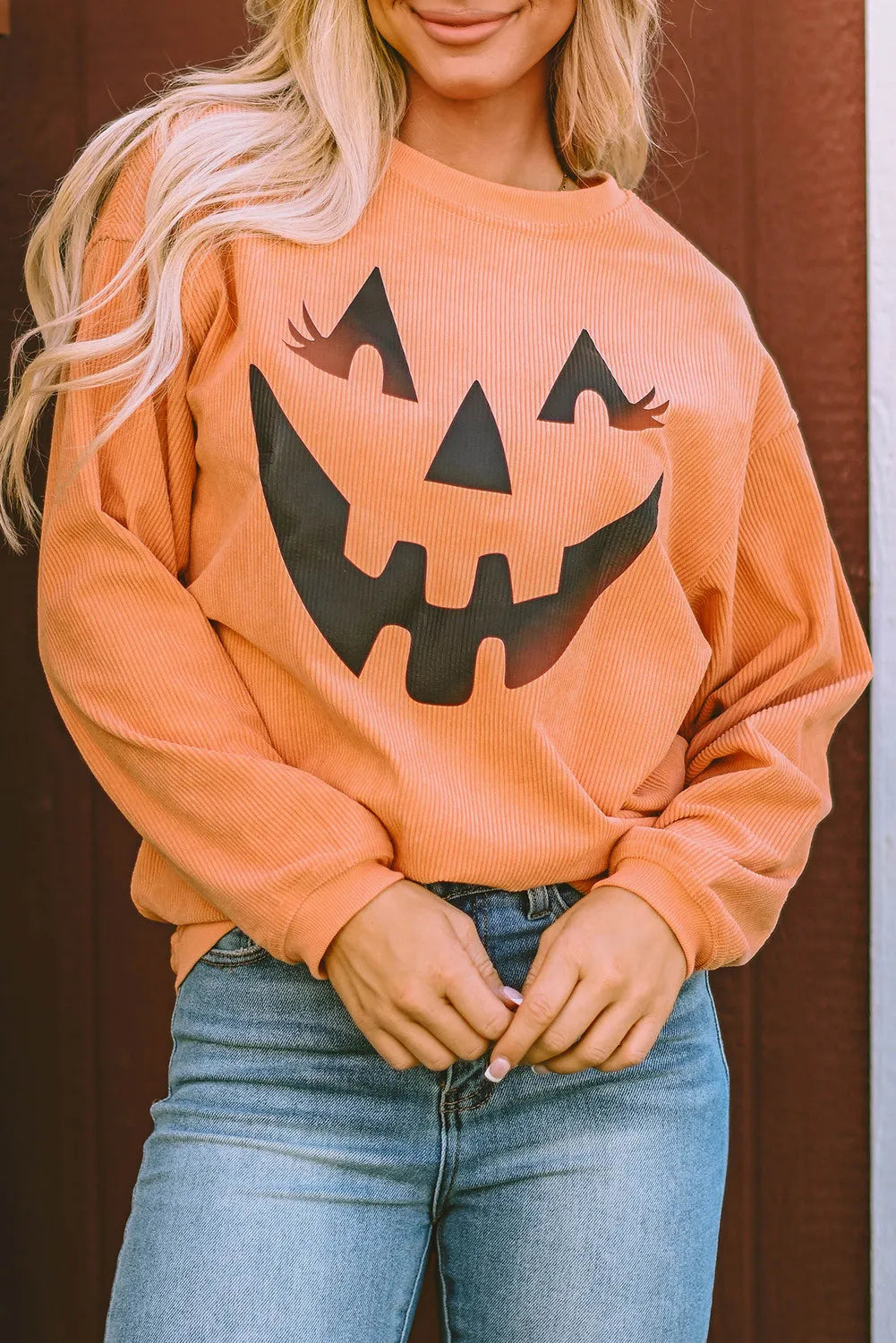 Caramel corduroy sweatshirt with jack-o'-lantern graphic and long sleeves.