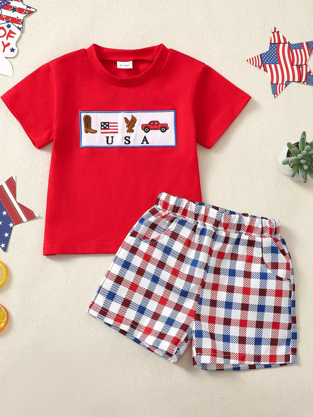 Red patriotic baby set with USA embroidery and plaid shorts.