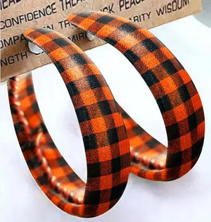 Orange and black buffalo check statement hoop earrings with alloy posts.