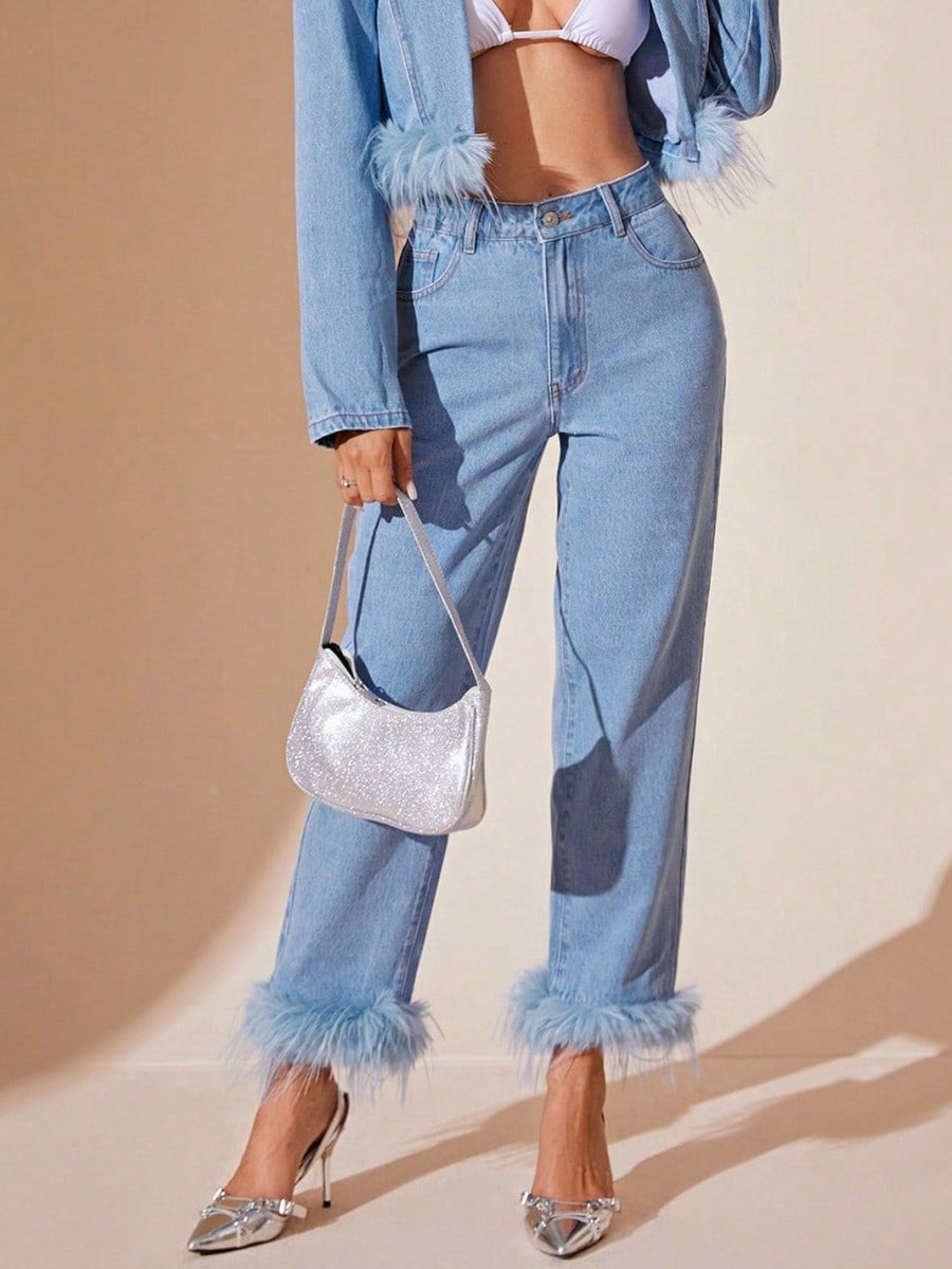 Light wash denim jeans with feather trim at the hem and high rise waist.