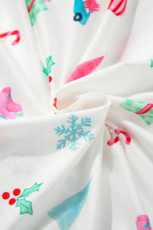 White pajama set with festive Christmas print including snowflakes, skates, and holly.