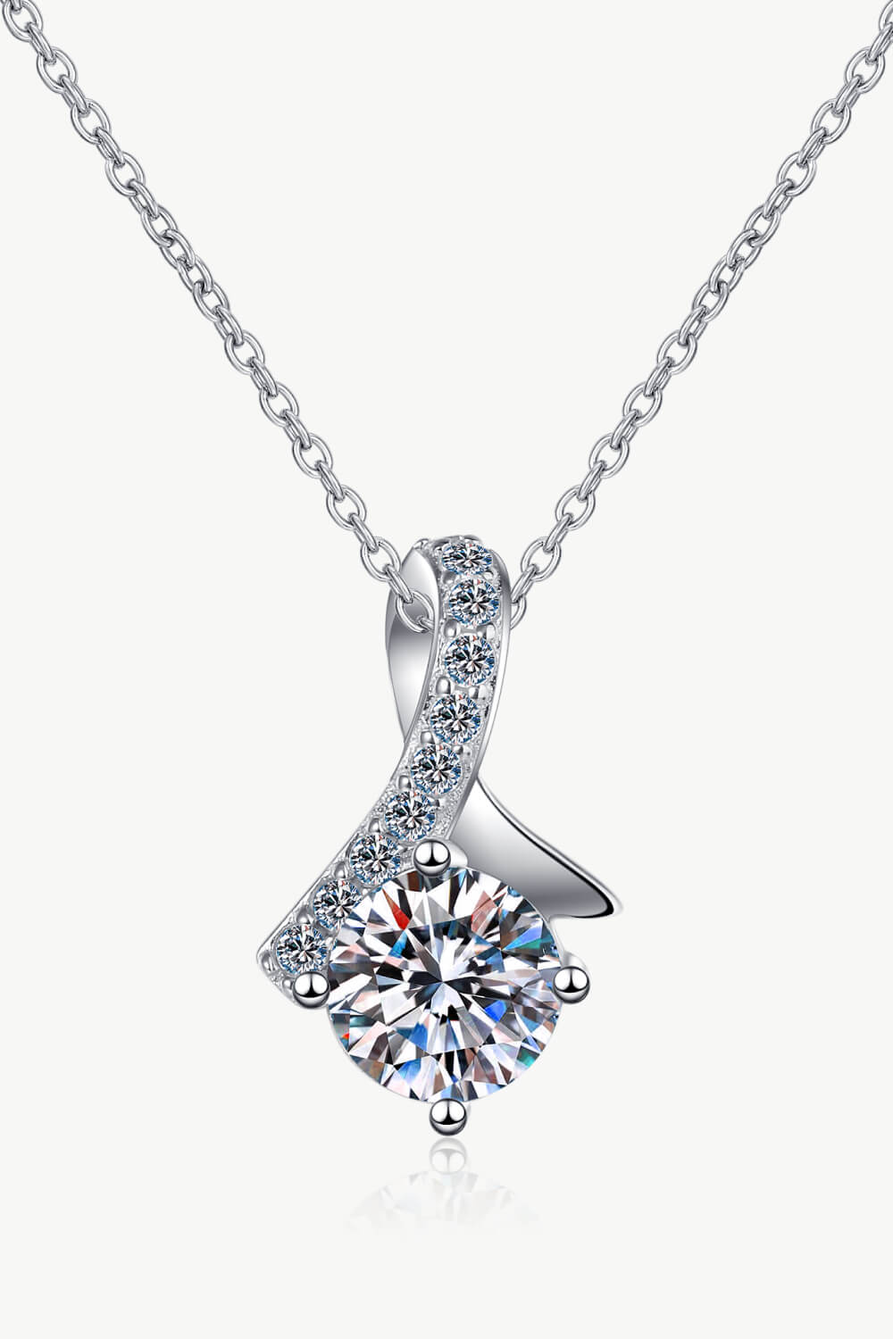 Silver pendant necklace with a large solitaire diamond and a ribbon of smaller diamonds.