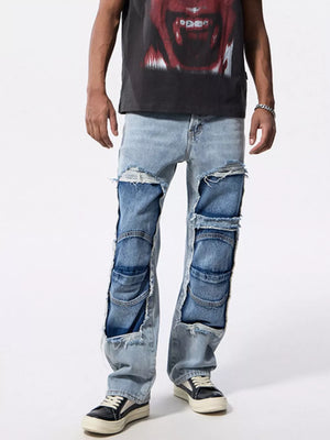 Men's light wash cotton jeans with distressed patchwork and ripped details.