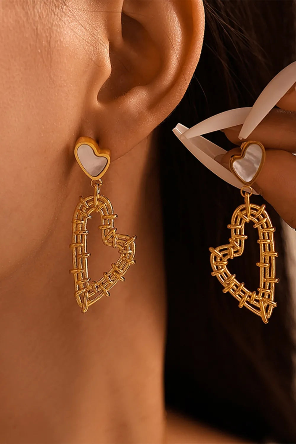 Gold woven heart drop earrings with white heart detail