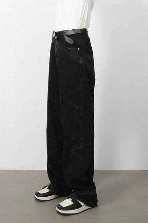 Faded black wide-leg denim jeans with a relaxed fit and subtle distressed details.