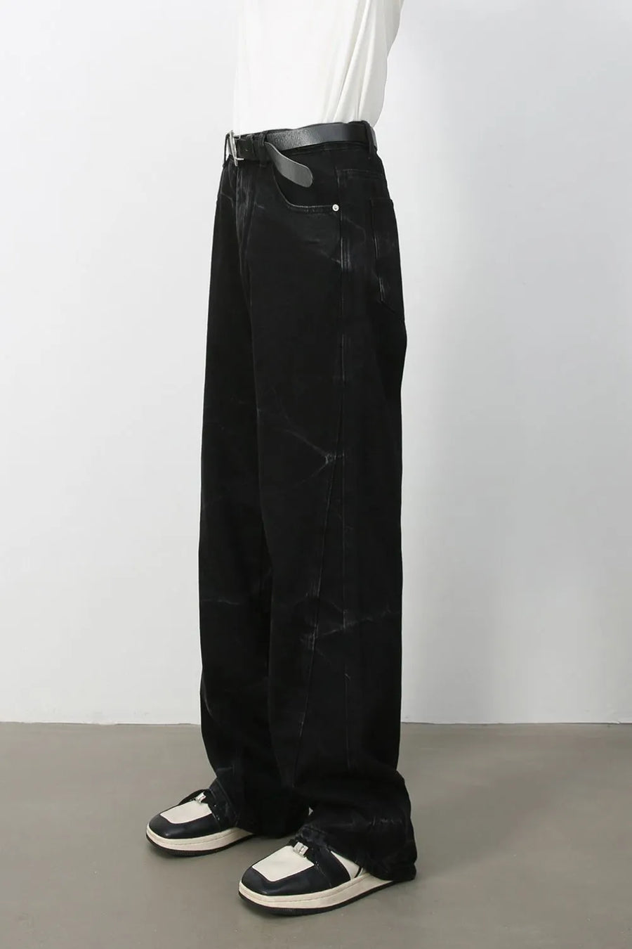 Faded black wide-leg denim jeans with a relaxed fit and subtle distressed details.