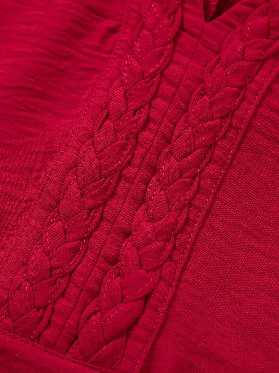 Deep red braided V-neck blouse with textured fabric and braided neckline detail.