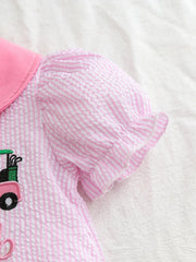 Pink and white striped baby dress with puff sleeves and golf cart embroidery detail.