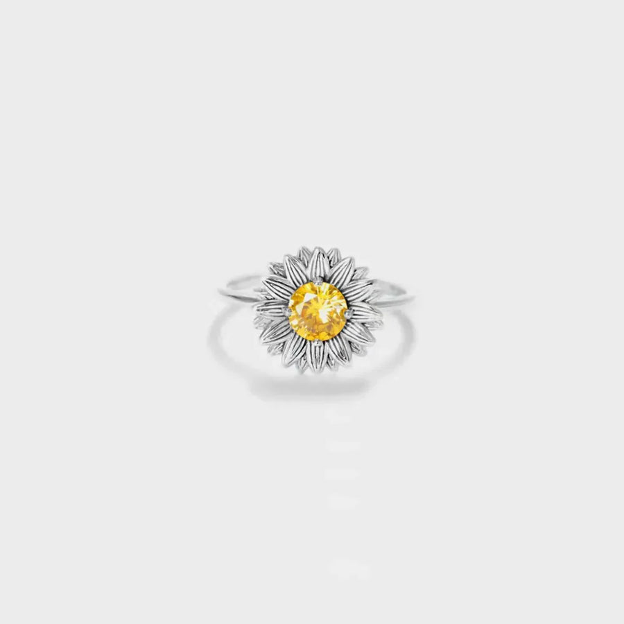 Silver sunflower ring with yellow gemstone center and detailed petals.