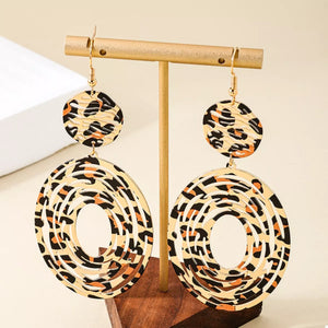 Bold dangle earrings with leopard print pattern and cut-out circles.