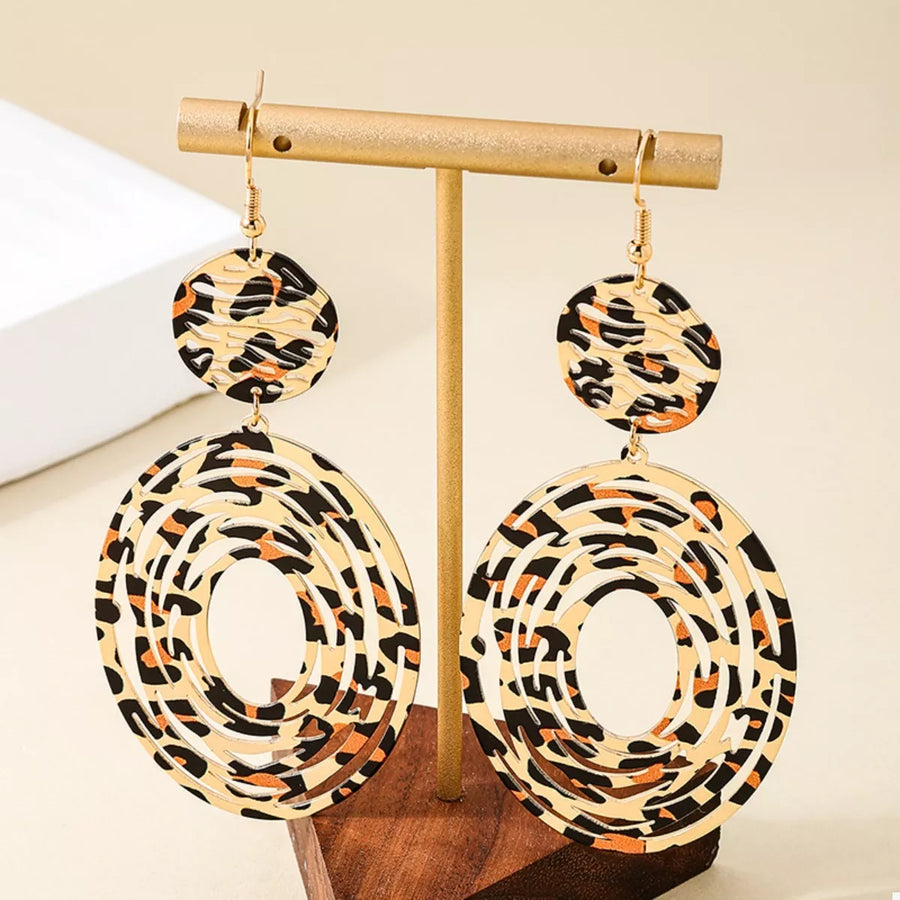 Bold dangle earrings with leopard print pattern and cut-out circles.