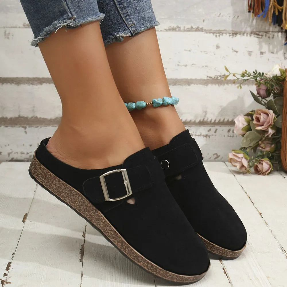 Black suede mule flats with buckle detail and cork sole