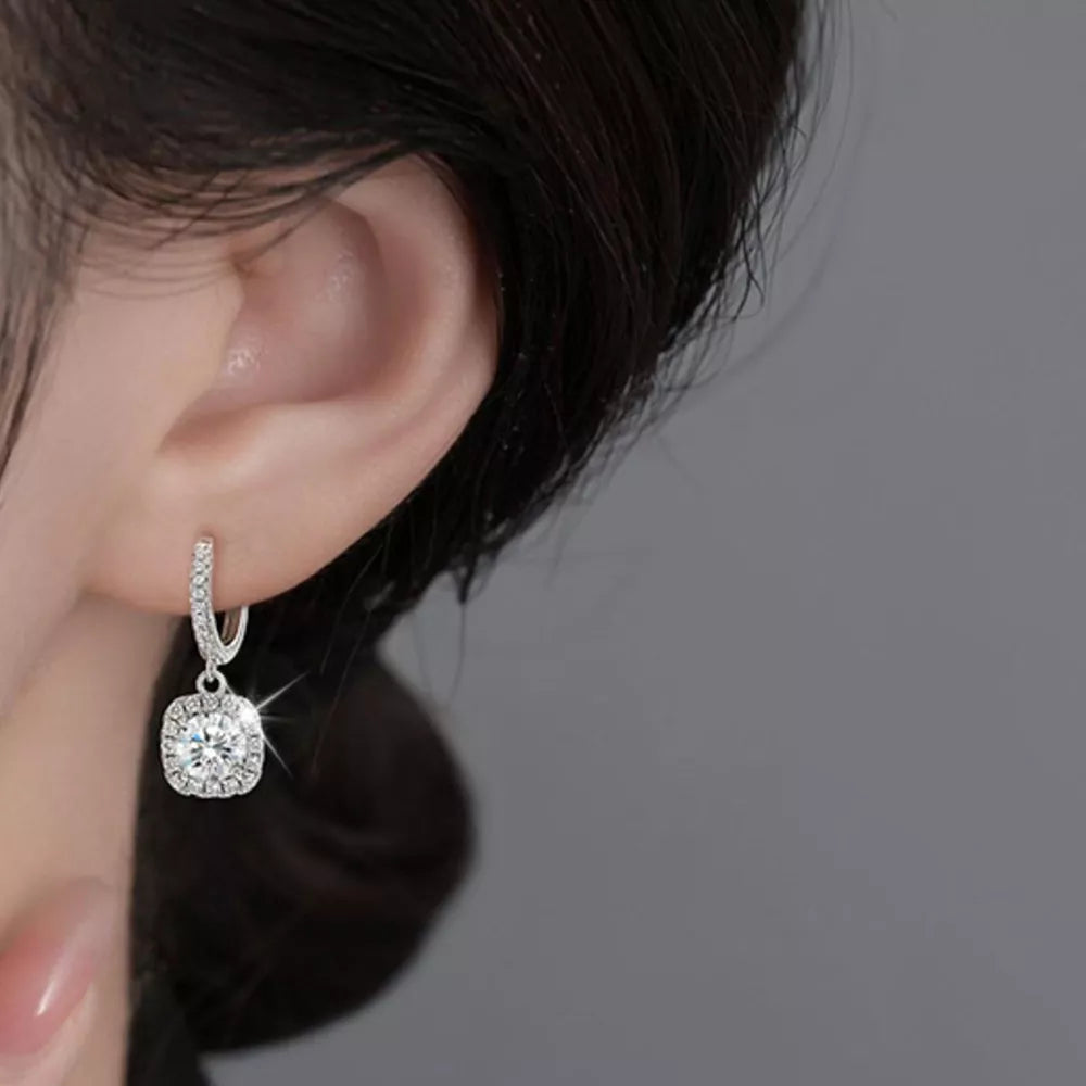 earrings in silver featuring moissanite stones and drop fit