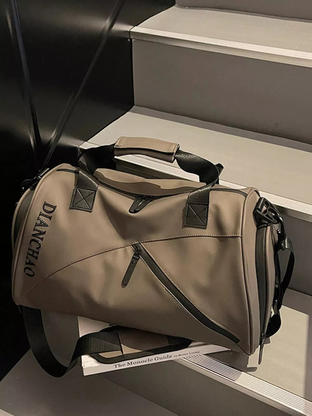 Spacious Oxford travel bag in champagne color with padded strap and zippered pockets.