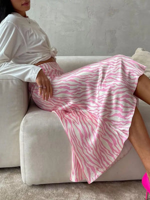 Pink and white zebra print satin midi skirt with a flowy A-line cut.
