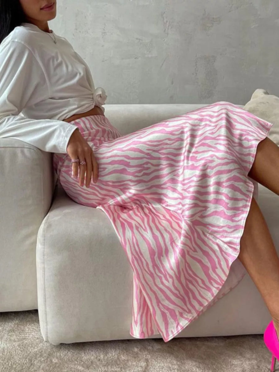 Pink and white zebra print satin midi skirt with a flowy A-line cut.