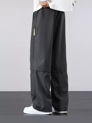 Men's gray cargo pants with a loose fit and zippered pocket detail.