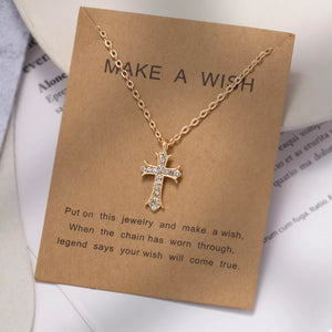 Gold rhinestone cross pendant necklace with delicate chain.