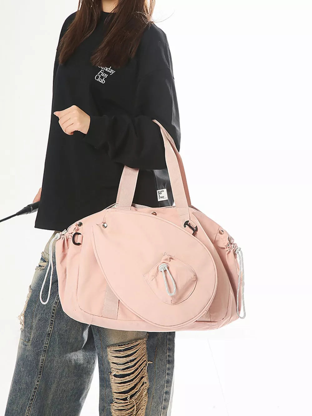 Pink nylon athletic tote bag with racket holder and cinch cord closure.