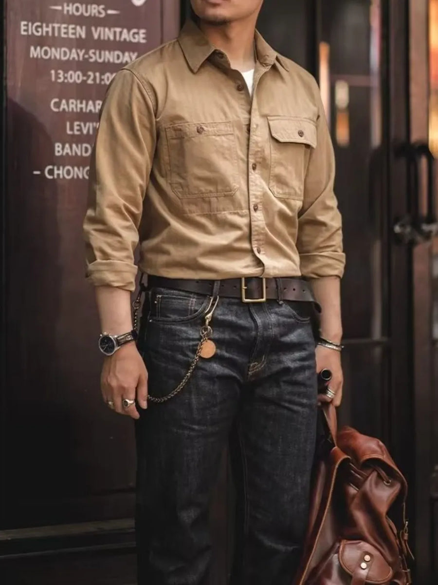 Khaki cotton twill utility shirt with two chest pockets and button front.