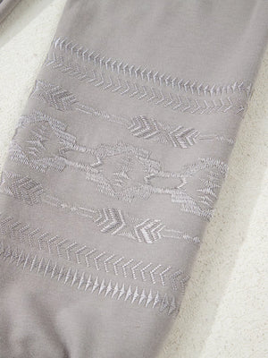 Gray sweatshirt with Aztec embroidery detail on sleeve