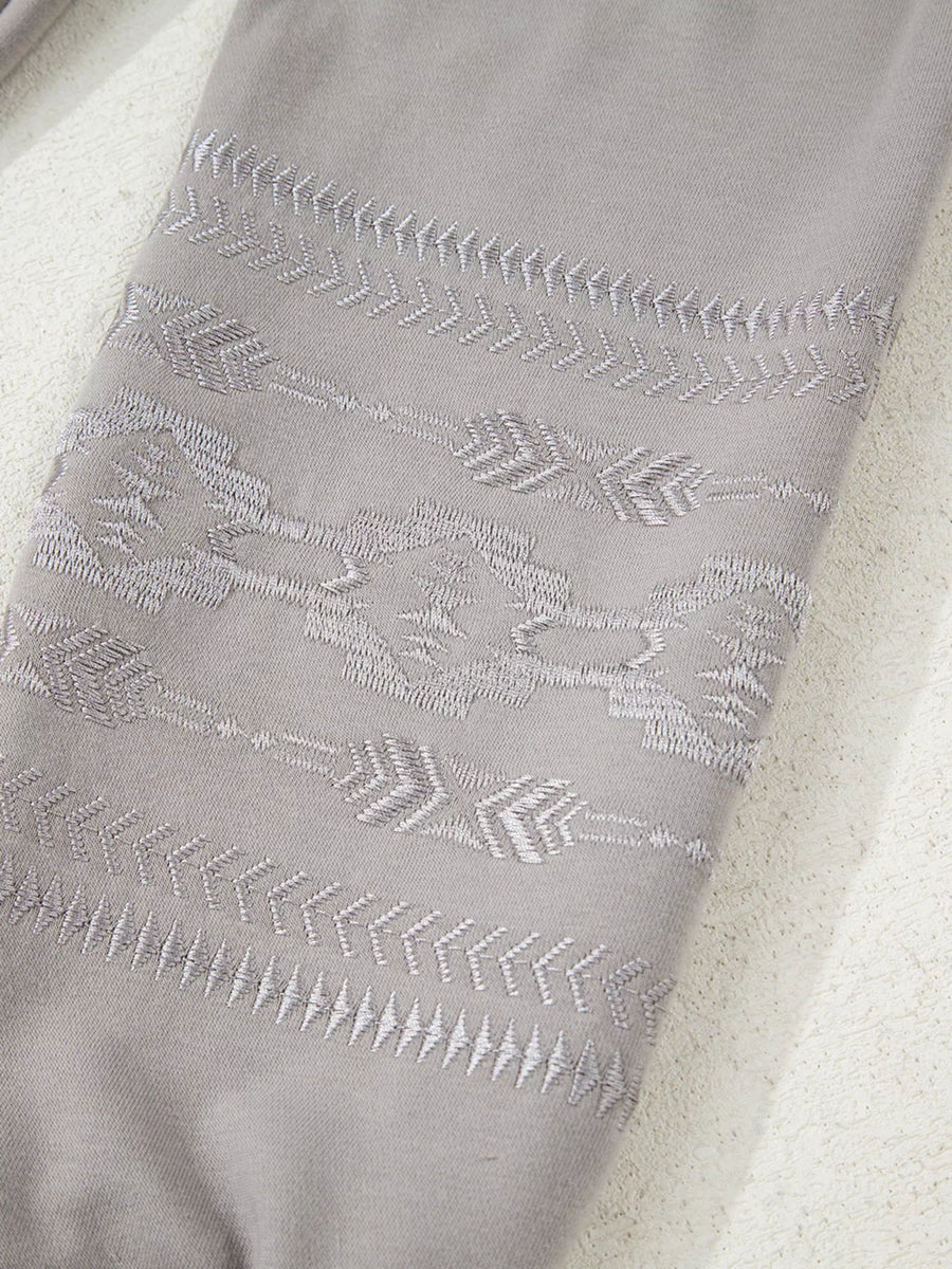 Gray sweatshirt with Aztec embroidery detail on sleeve