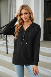 Black textured henley hooded knit top with button detail and drawstring hood.