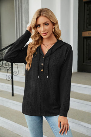 Black textured henley hooded knit top with button detail and drawstring hood.
