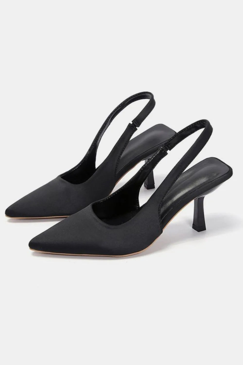 Black satin slingback pumps with sculpted heel and pointed toe