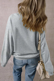 orange sweatshirt featuring graphic print and floral