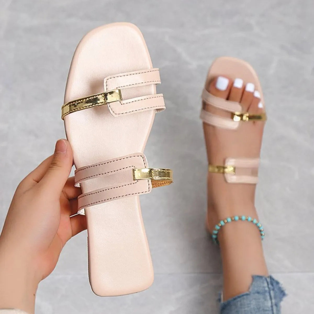 Metallic accent flat slides in apricot with double straps and gold hardware.