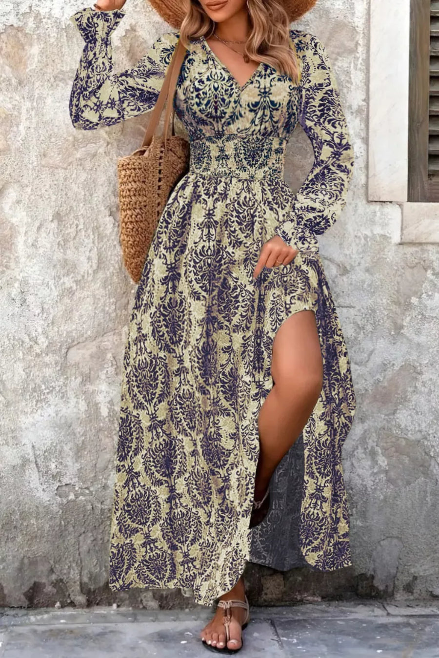 Maxi dress with bishop sleeves, cinched waist, and high slit in a navy and sage print.
