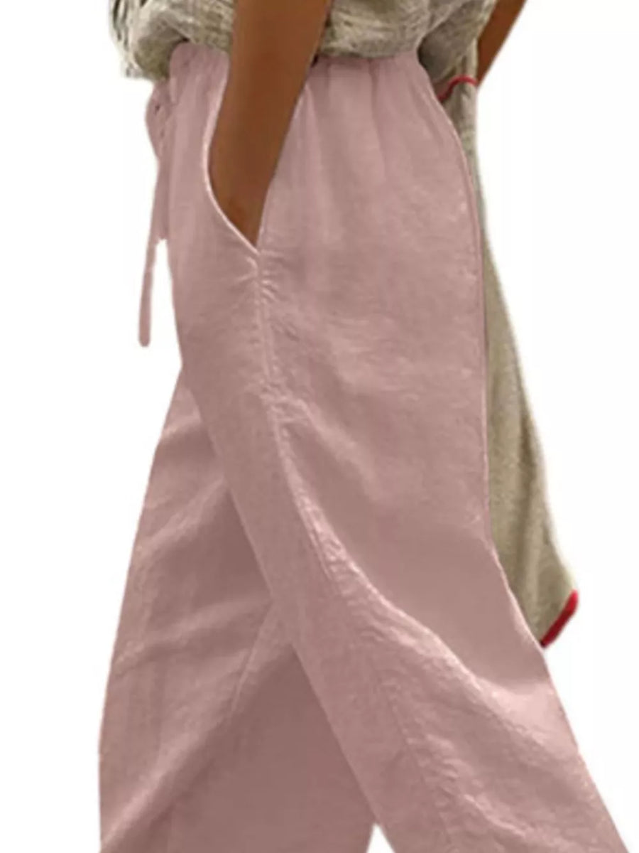 Dusty pink maternity pants with drawstring and pockets, relaxed fit cropped style.