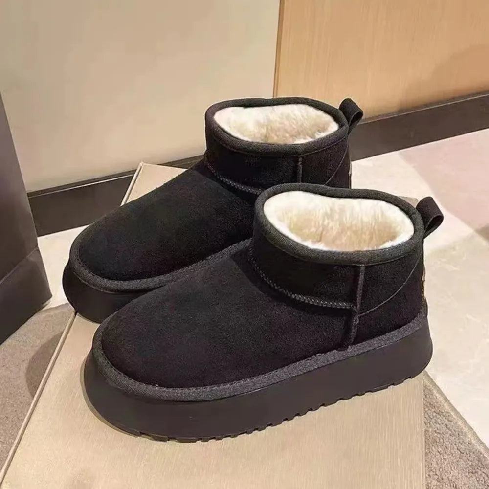 Black shearling platform ankle boots with a thick sole and cozy lining.