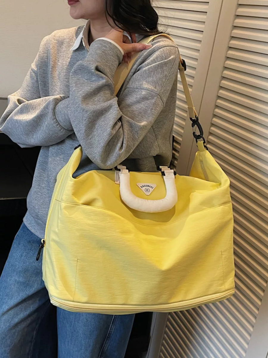 Luxurious Oxford Cloth Duffel Bag in bright yellow with white handle detail and shoulder strap