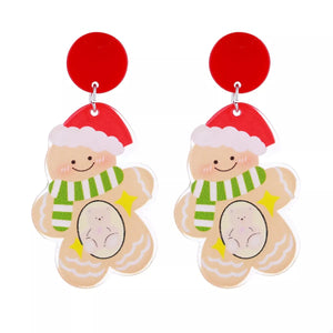 Festive Christmas gingerbread man dangle earrings with red tops and green striped scarves.