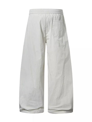 Men's cream white wide-leg cargo pants with elastic waist and back pocket.