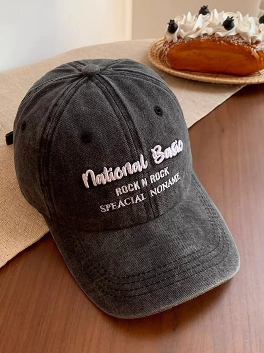 Black washed baseball cap with white embroidered text.
