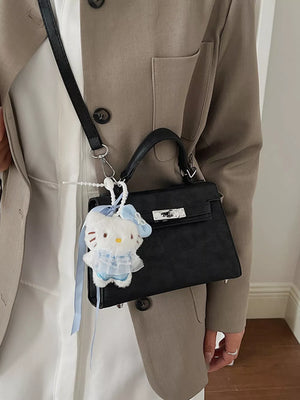 Black croc-embossed mini crossbody bag with a Hello Kitty charm.