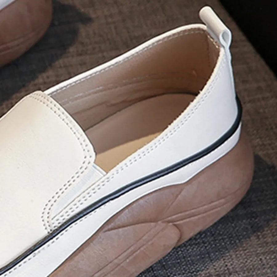 Ivory slip-on sneakers with a sculpted platform sole and pull tab.