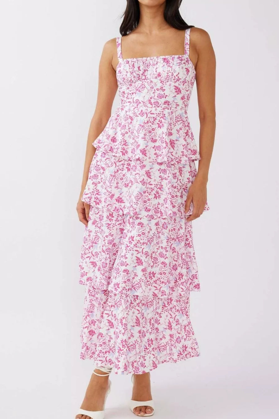 Maxi dress with pink floral print, square neckline, tiered skirt, and spaghetti straps.