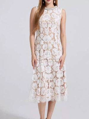 White lace dress with pearl neckline and scalloped hem.